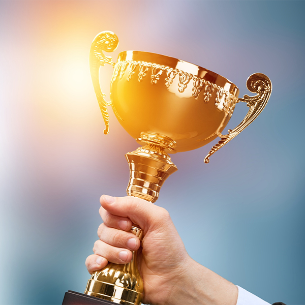 Hand holding a tropgy